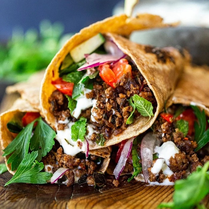 Hot cumin lamb wrap with crunchy slaw and spicy mayo